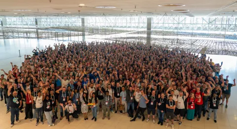 Large group of people at DrupalCon Barcelona 2024 posting for a group photo.